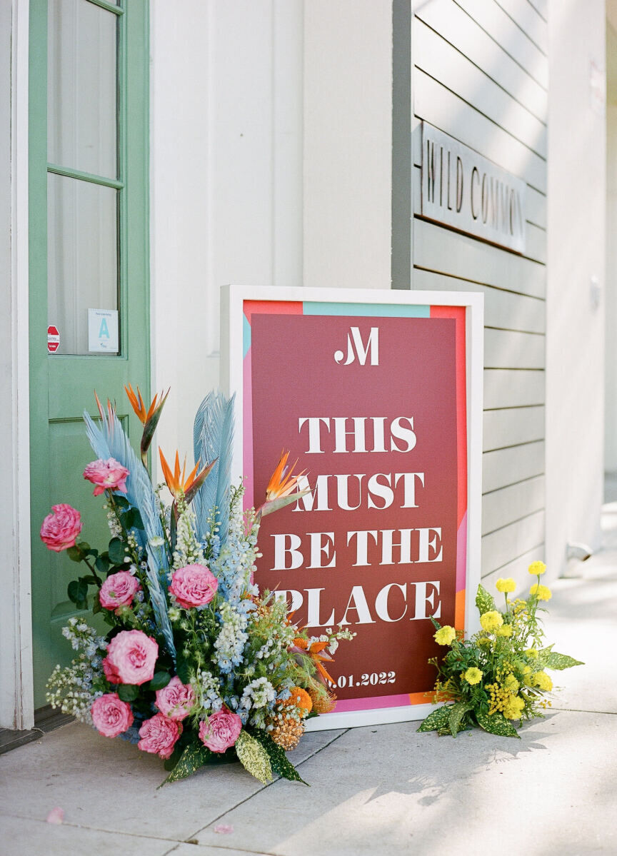 A multi-color sign and floral arrangements greeted guests as they arrived at Cannon Green for an art-inspired wedding.