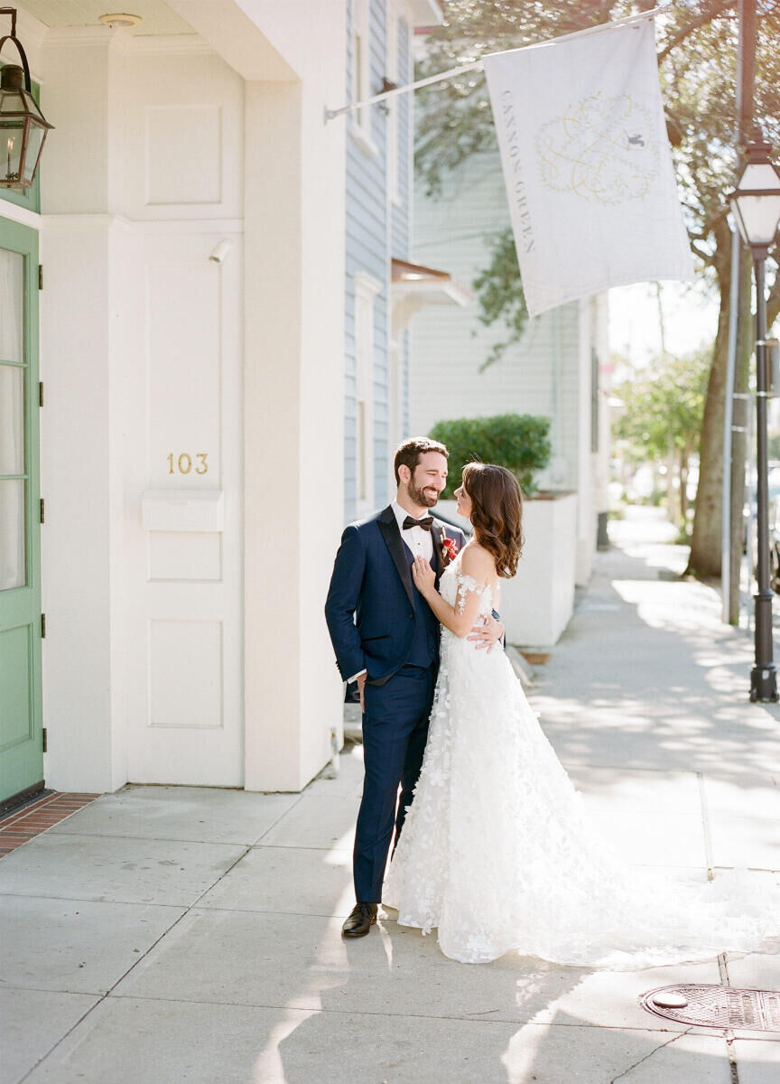 A groom and bride embrace outside of Cannon Green, where their art-inspired wedding took place.