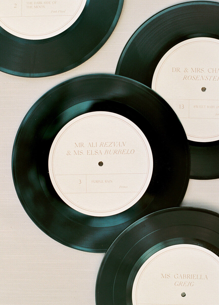 Customized vinyl records were used instead of traditional paper escort cards at the reception of an elegant spring wedding for music lovers.