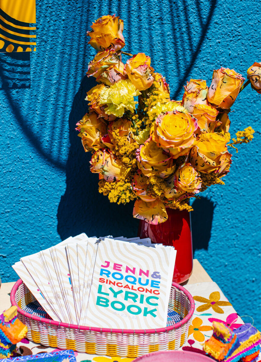 This vibrant outdoor wedding reception incorporated a sing-a-long, and the couple provided their guests with lyric books so they knew all the words.