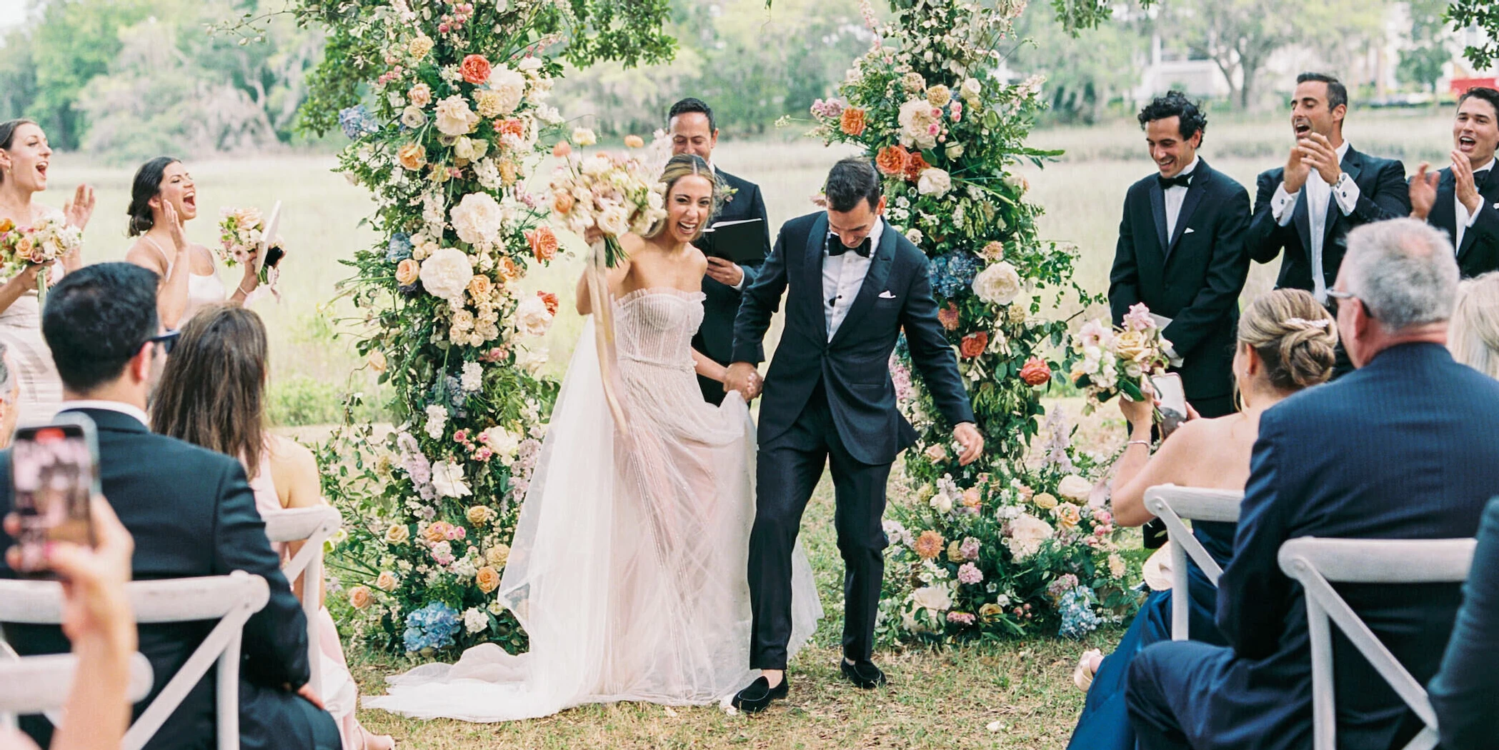 A groom stomps on a glass at the end of a Persian- and Jewish-infused outdoor ceremony at his elegant spring wedding at Kiawah River in South Carolina.